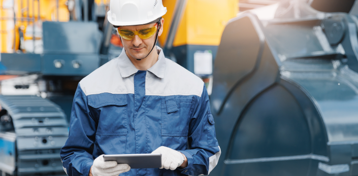 Frontline worker using a tablet at a construction site.